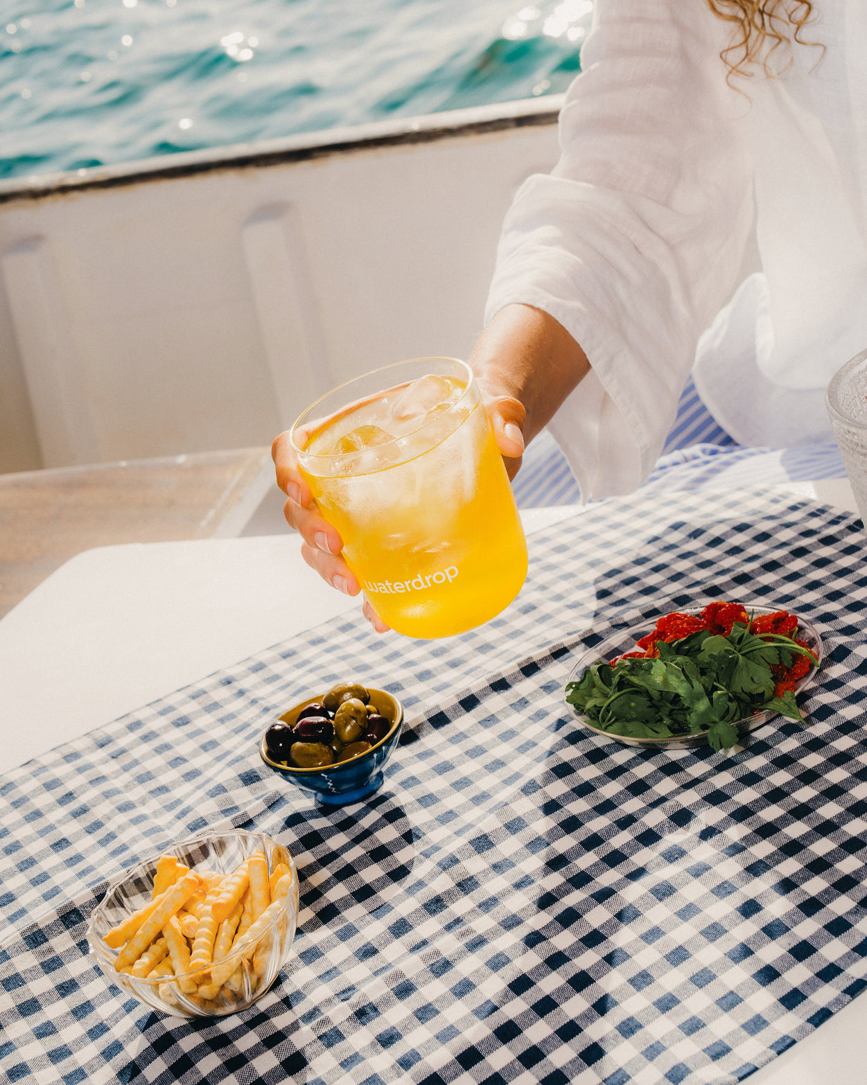 ORANGE microdrink beside culinary delights.