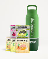 Green reusable water bottle with a handle and a stack of assorted flavor boxes beside it.